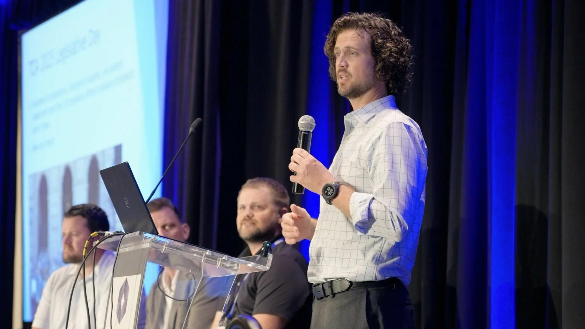 Speaker addressing the audience on stage at TCA Chiro Texpo '25, frame from the highlight video